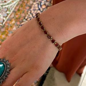 Vintage gold toned sterling silver dark red stoned tennis bracelet.